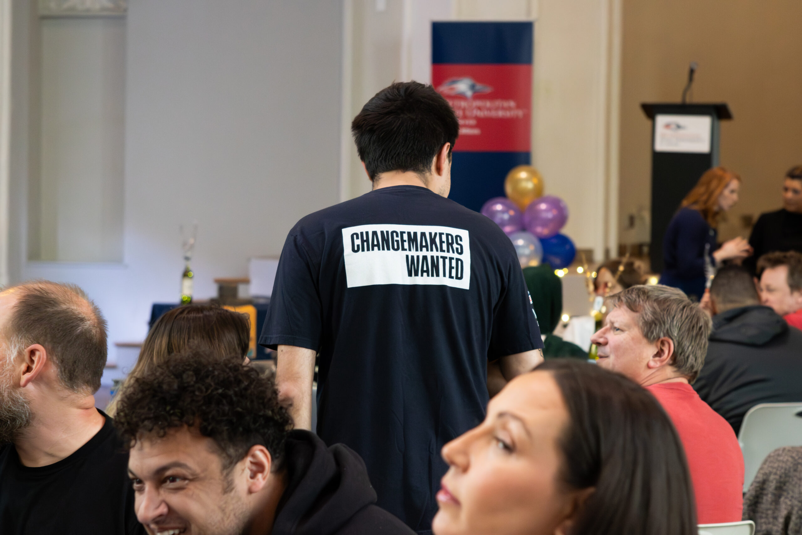 MSU Denver employee standing wearing a shirt that says, 
