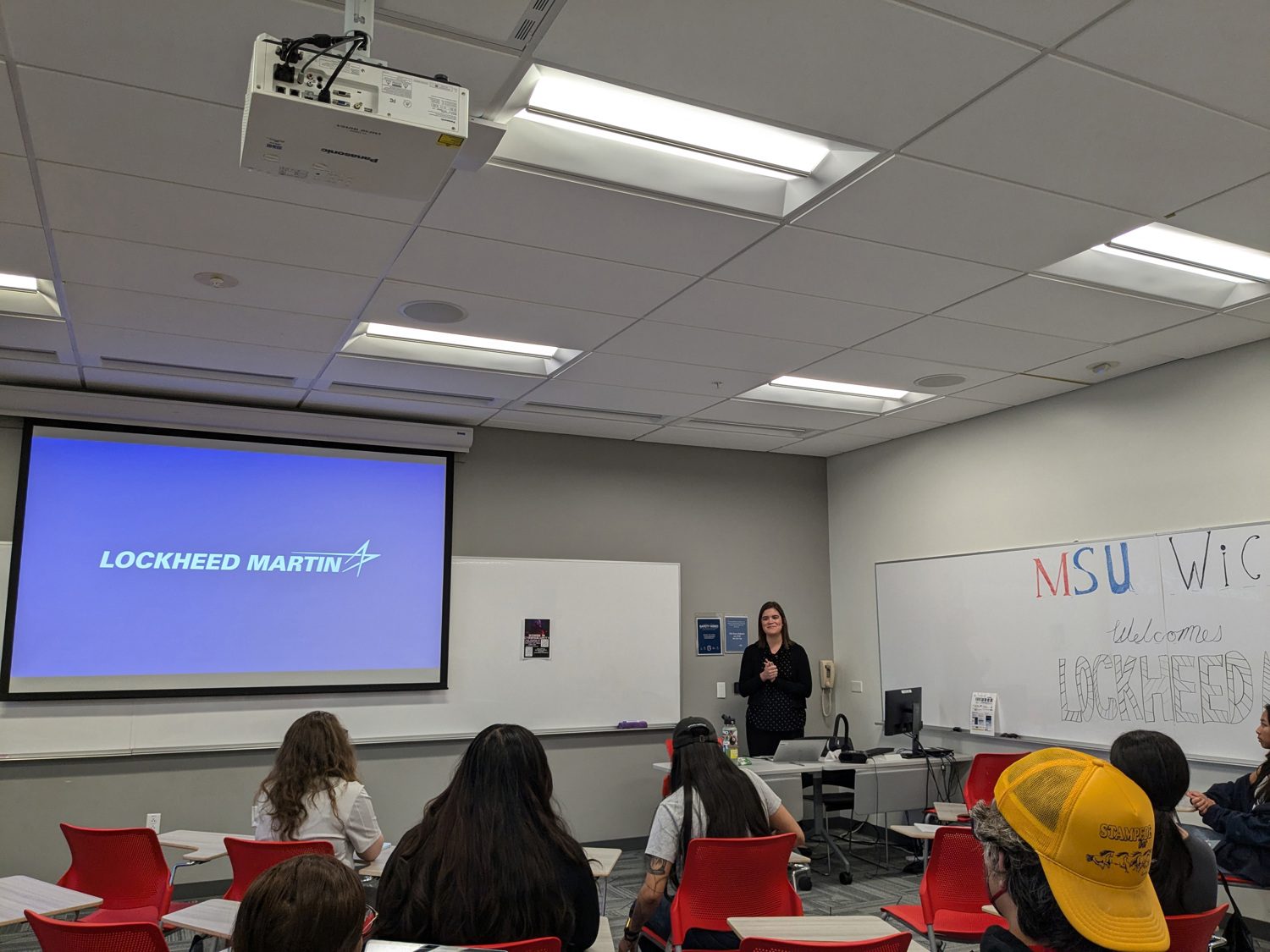 Students in a classroom listening to guest speaker