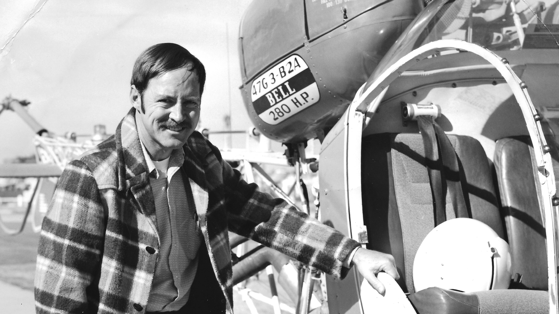Roy Morgan standing next to an airplane
