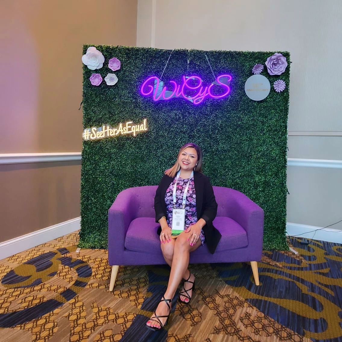 Woman sitting on couch at the Women in Cybersecurity Conference in Dallas TX
