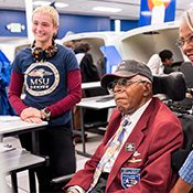 Original Tuskegee Airmen pilot James H. Harvey III, watches students flying simulated aircraft along with his daughter (right) Alysyn Harvey-Green, Computer Information Systems lecturer.