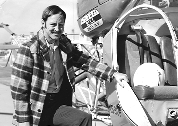 Roy Morgan standing next to an airplane