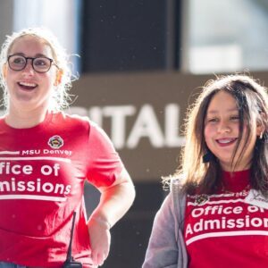Two students smiling with a red MSU Diversity shirt on.