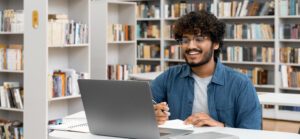 online student smiling at laptop