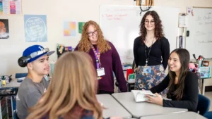 MSU Denver student Ariana Rabinovich, right, talks with students at North High School with teacher Heidi DeBernardi, whose mentorship inspired Rabinovich to pursue a career in education. Photo by Alyson McClaran