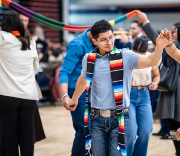 Students and families dancing at Latine Graduation Ceremony
