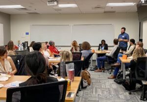 New MPAcc student Anthony stands up and introduces himself in the midst of a full classroom of new MPAcc students in our Fall '26 orientation