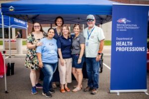 Health Professions staff under a tent
