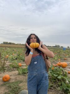 Mya Sharp holding a pumpkin cutely