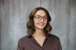 Woman with brown hair wearing glasses