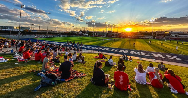 Spectators at MSU soccer match at sunset
