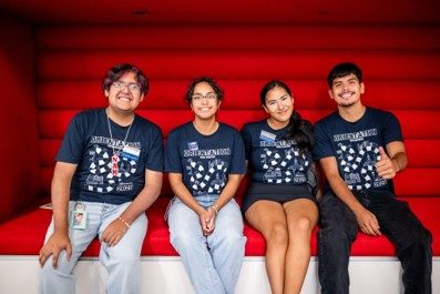 Four students sitting in a cubby