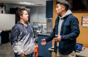 Two students talking in the Met Media office