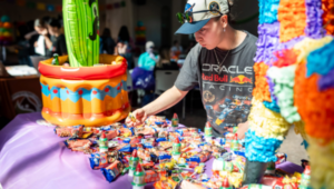 Student picking out candy at a Latine themed event