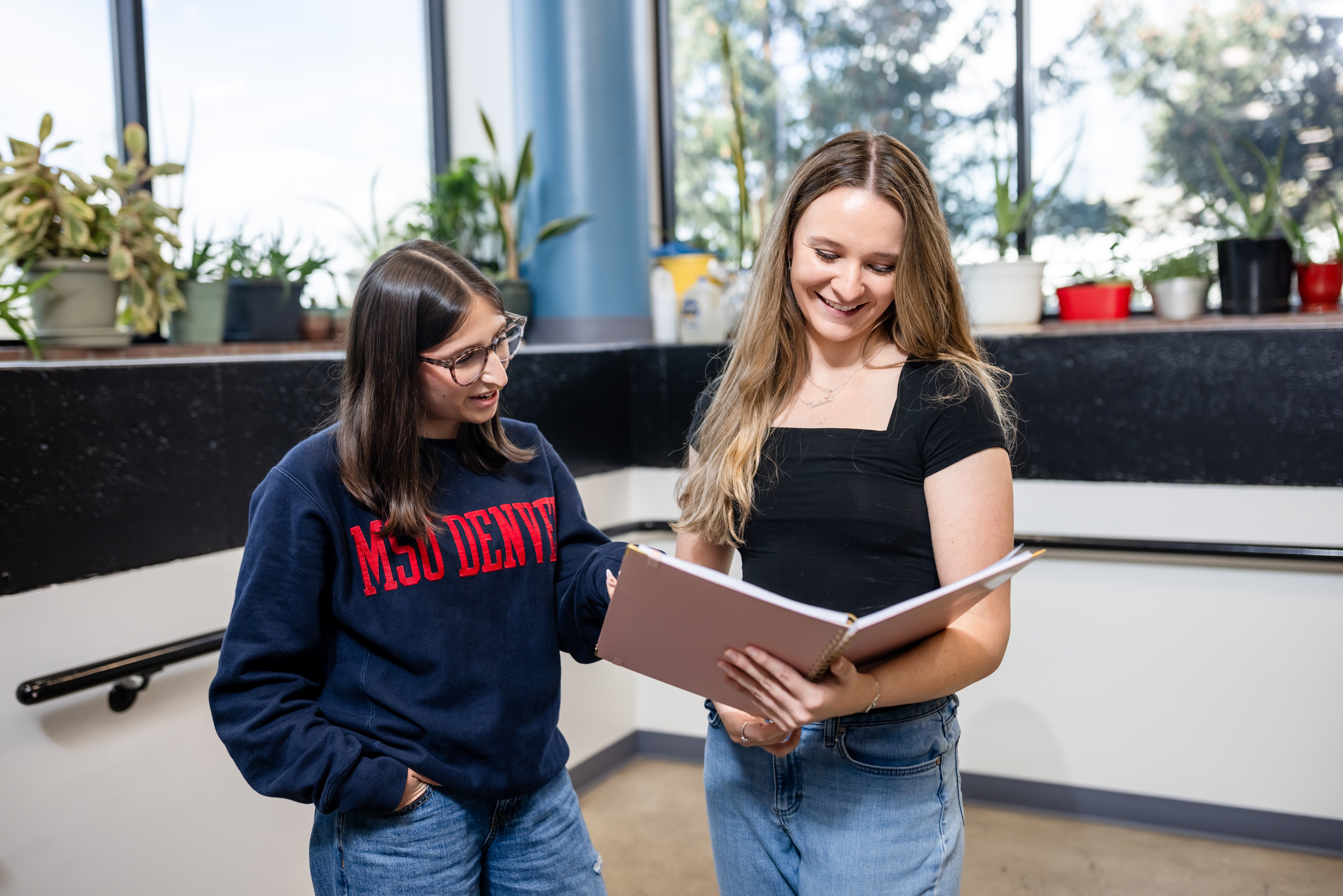Two students reading a book together