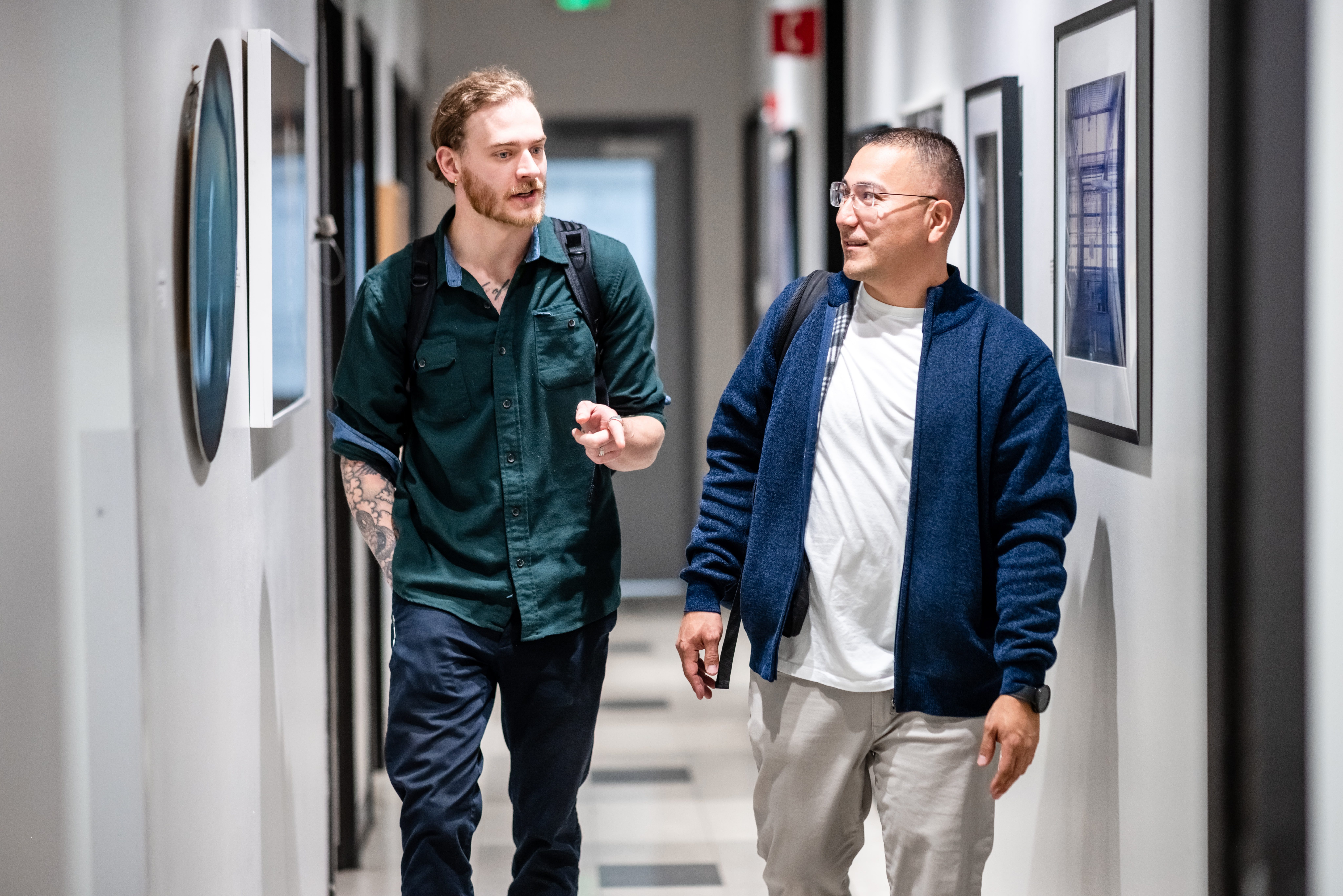 Two students talking in a hallway