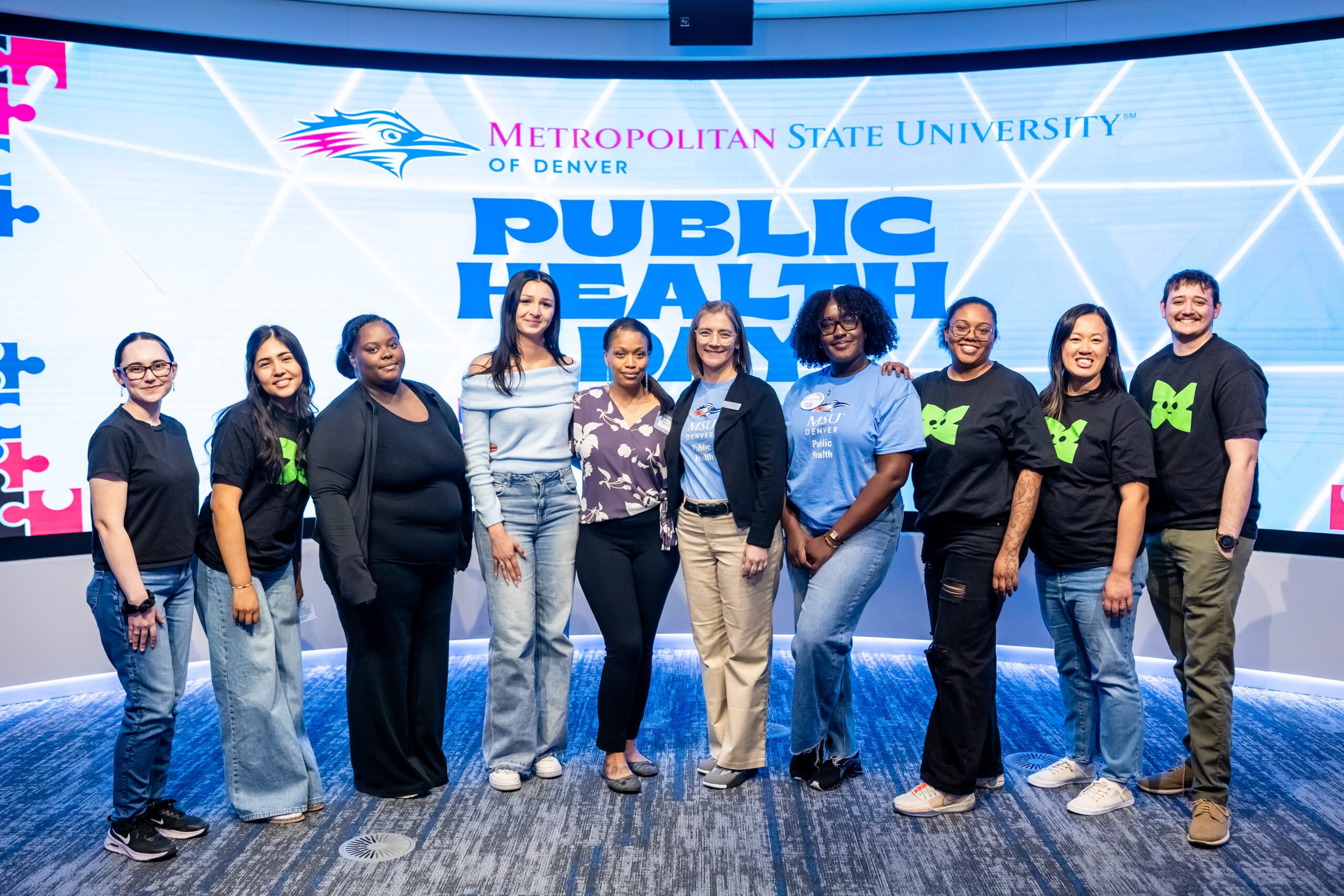 Group of students standing in front of a screen that says MSU Denver Public Health Day