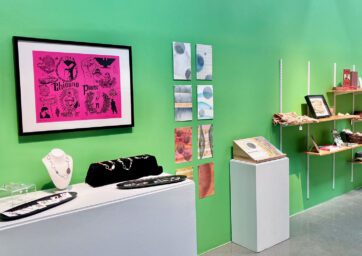 A gallery at CVA is set up like a shop with objects displayed on pedestals, wall shelves, and racks.