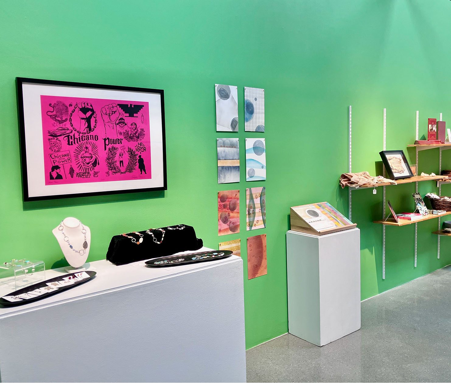 A gallery at CVA is set up like a shop with objects displayed on pedestals, wall shelves, and racks.