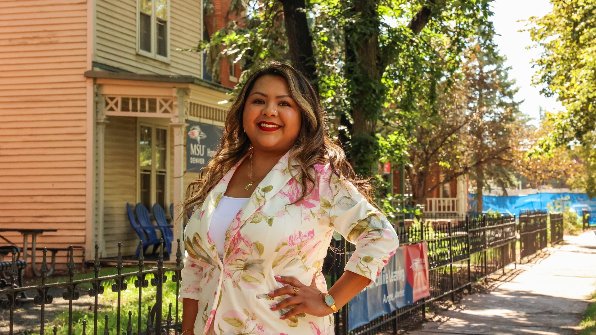 Rebeca Saavedra standing in front of the MSU Denver Honors Program building in 9th Street Park