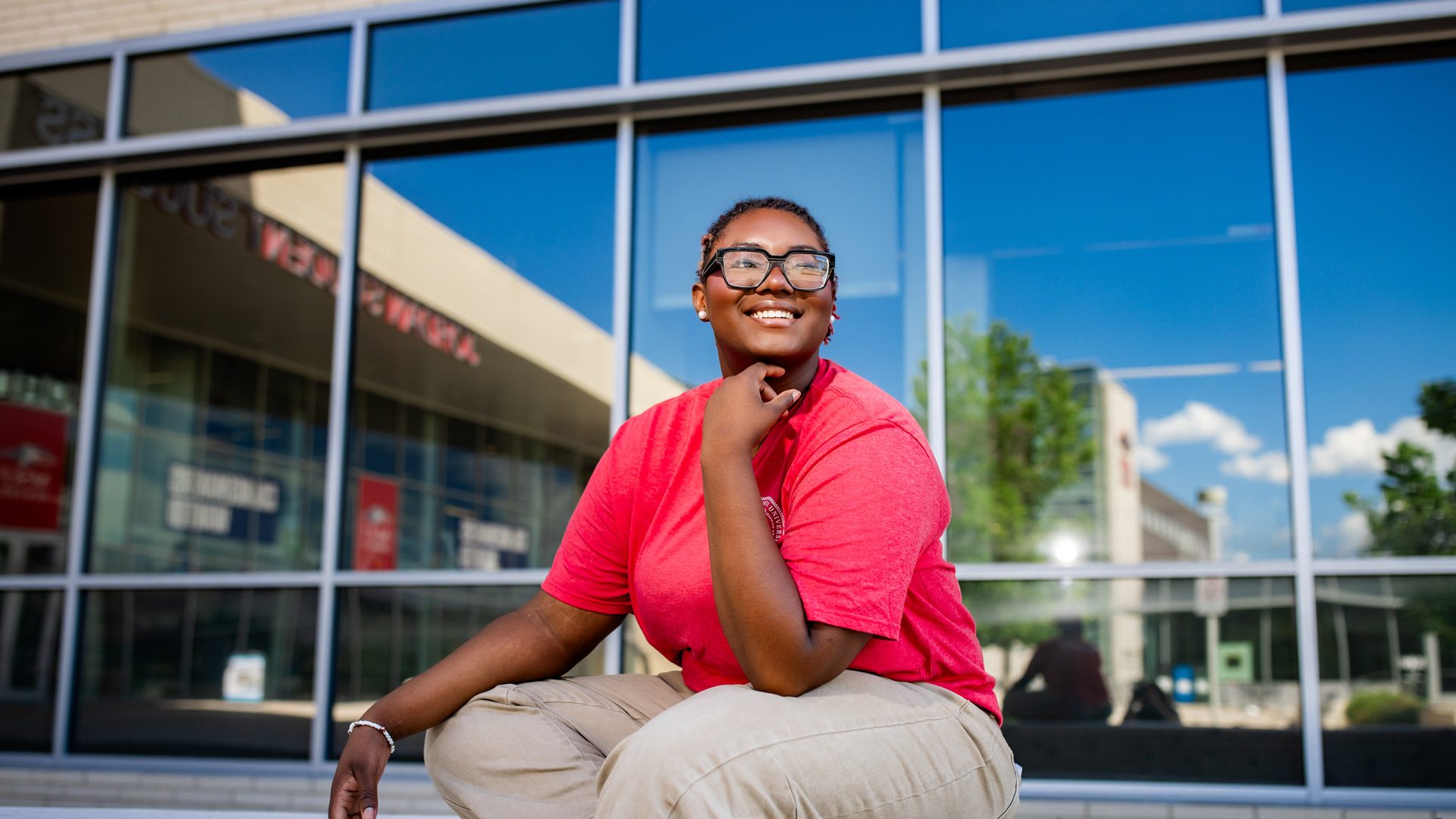 MSU Denver student Sanaa Walker sitting and smiling in front of JSSB
