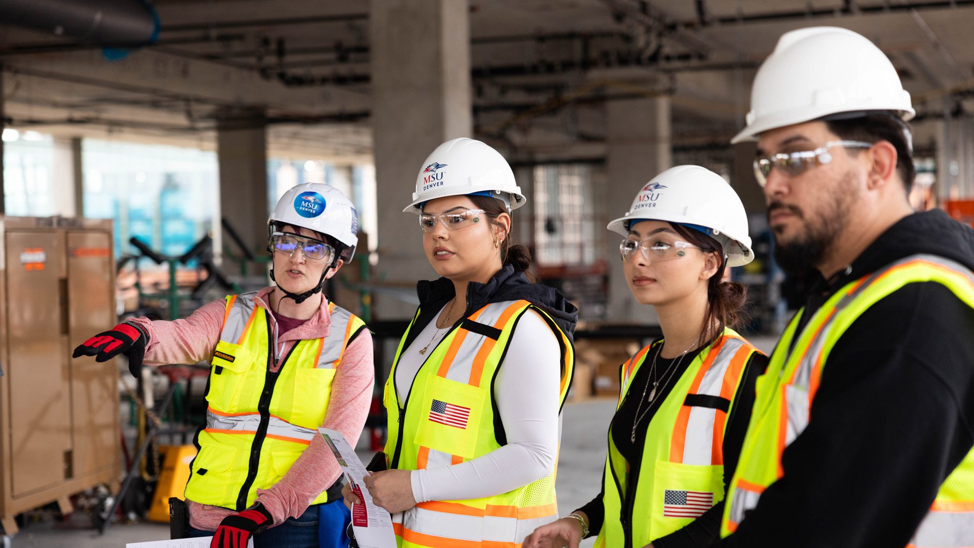 From left to right, Carolyn McGary, assistant professor and director of Construction Project Management in the Department of Engineering and Engineering Technology, chats with her students Kimberly DeSantiago and Casandra Chacon during the Summit House construction tour. Photo by Amanda Schwengel.