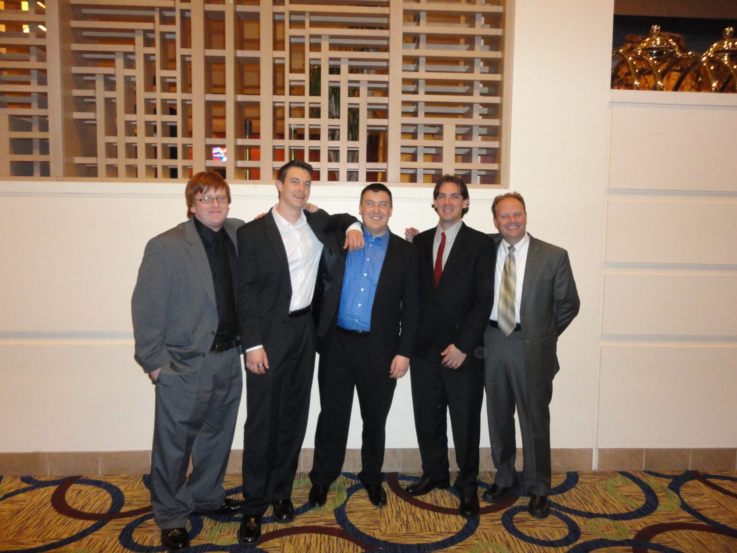 Richard Moeller and four Model UN students in 2011, wearing suits and posing together in a hotel hallway.