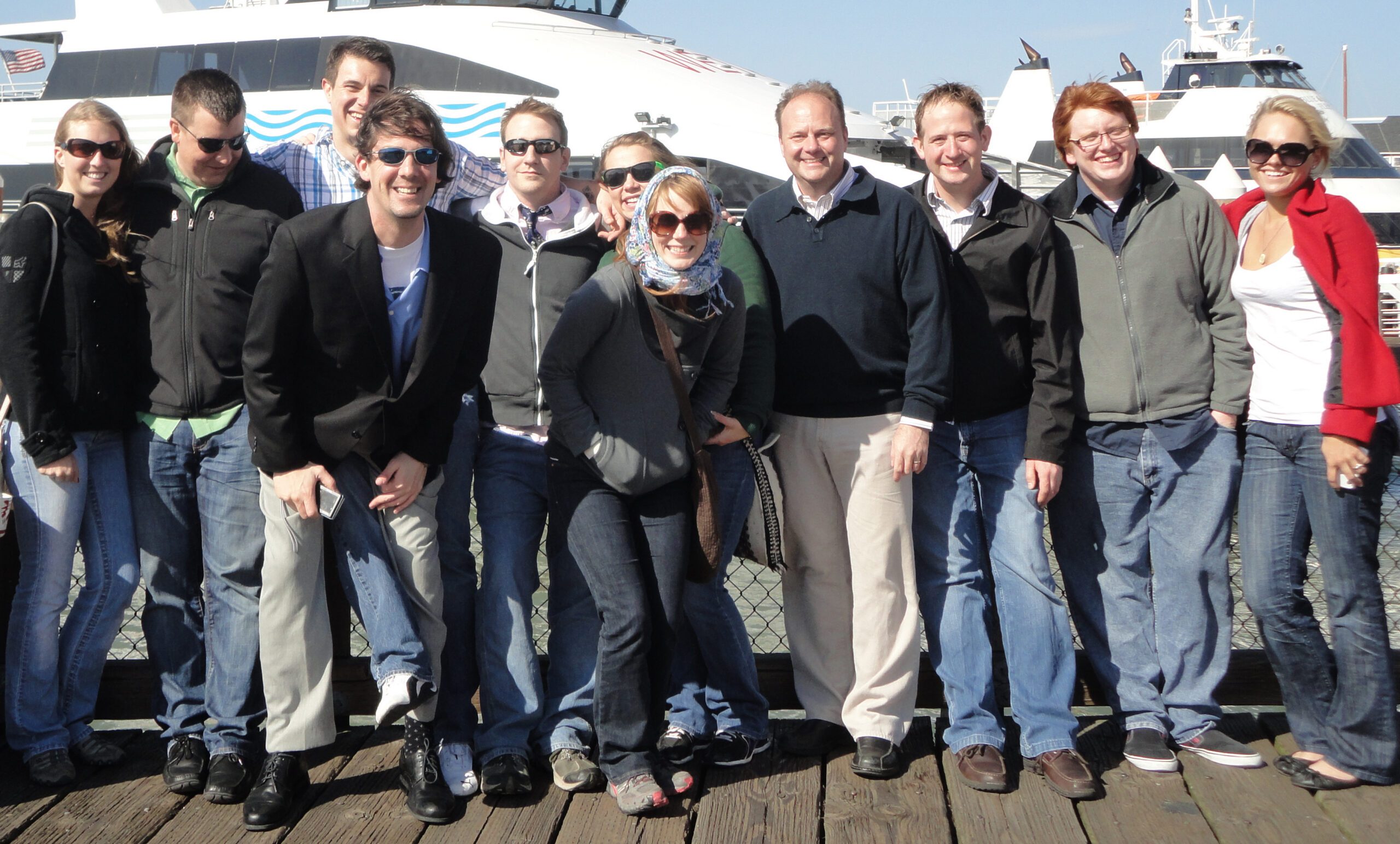 Richard Moeller and ten Model UN students in 2011, posing for a group photo on a pier in front of a docked ferry.