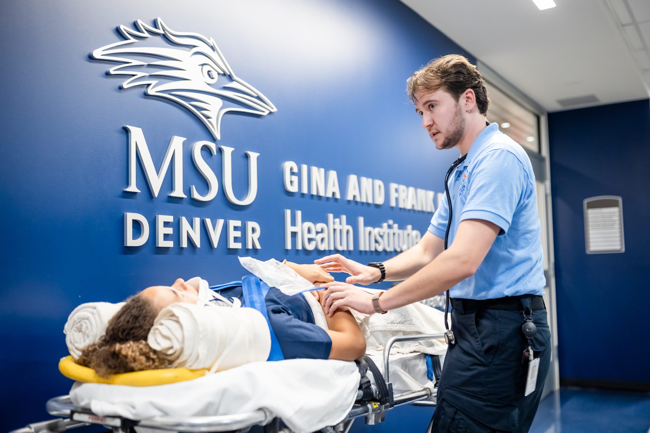 EMT student standing in front of a patient.