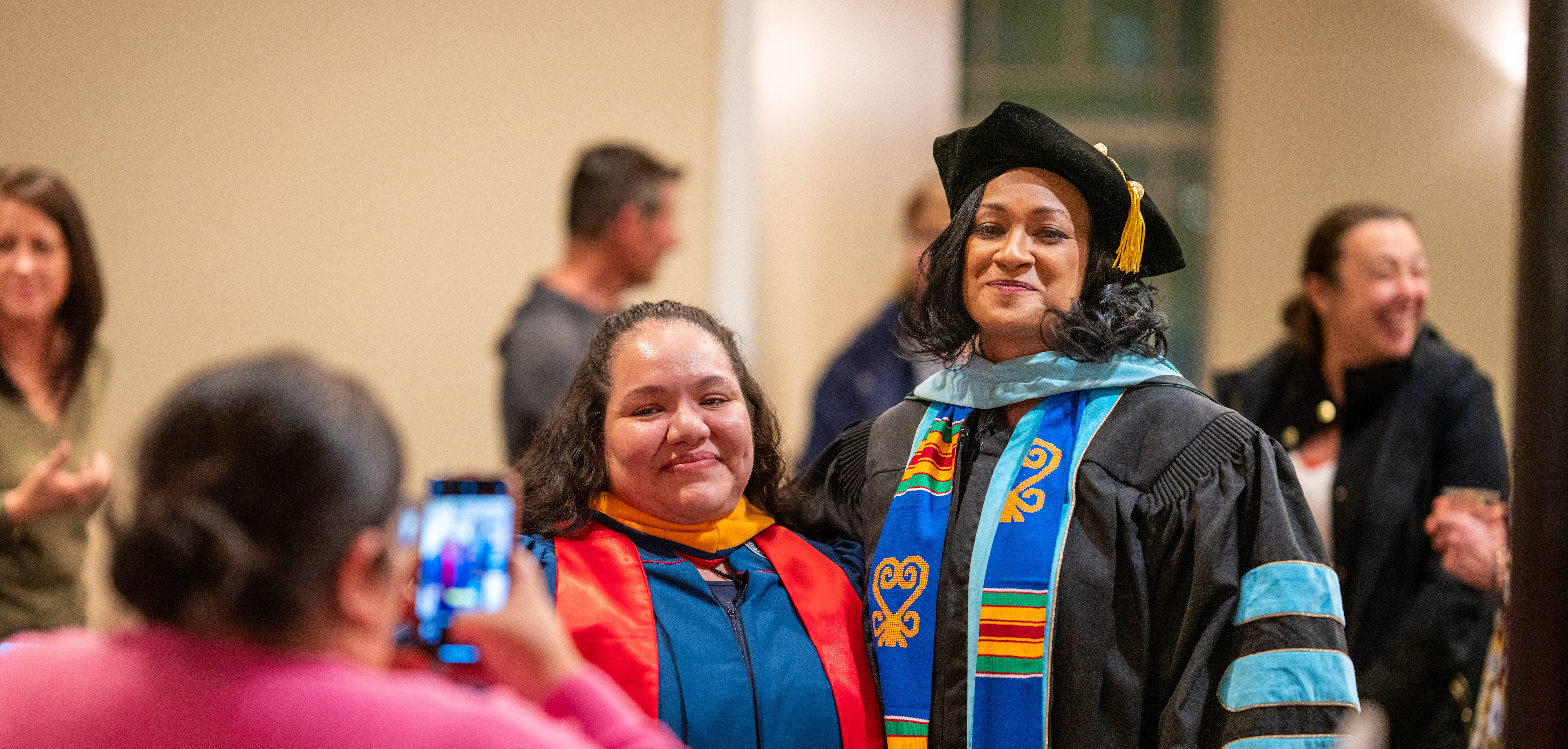 Dr. Tricia standing with student for graduation.