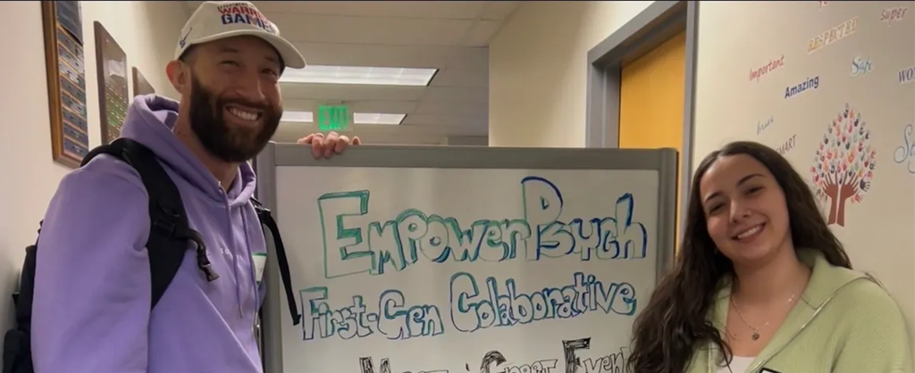 Two students standing in front of a mobile whiteboard.