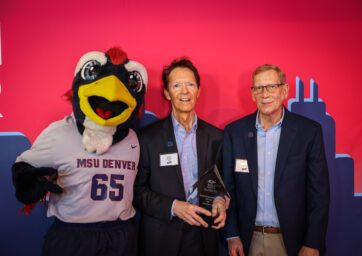 Elliot Morgan, Doug Earhart and Rowdy the Rowdrunner with Elliot's alumni award