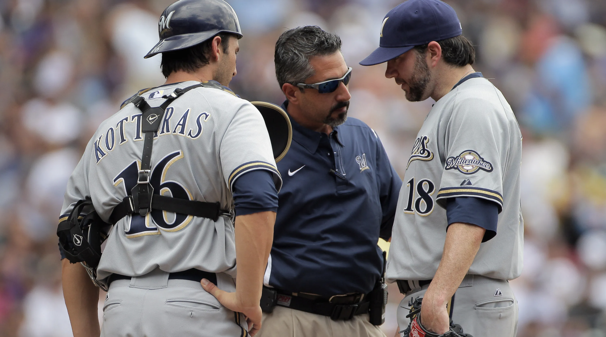 From left: Milwaukee Brewers catcher George Kottaras, athletic trainer and MSU Denver alum Roger Caplinger and pitcher Shaun Marcum confer during a game.
